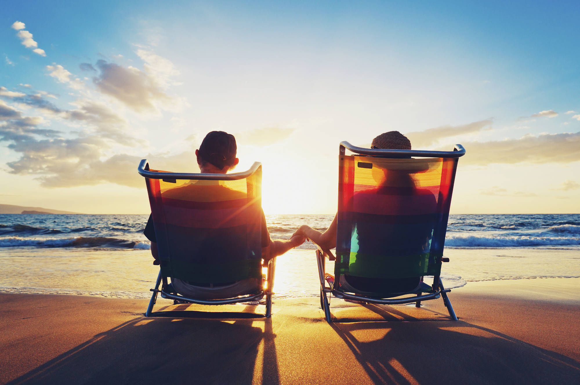 Happy retired couple enjoying the sunset